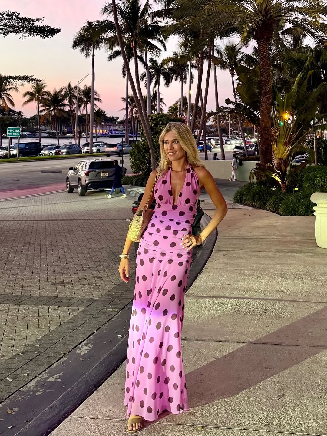 Pink polka dot halter maxi dress paired with gold metallic accessories for an ef